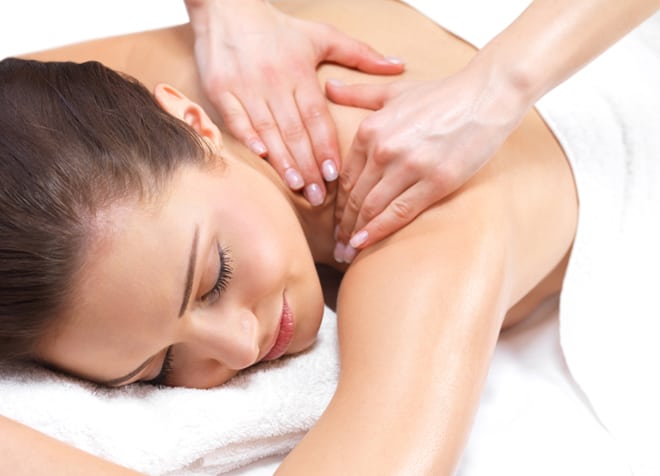 Woman receiving shoulder massage at Holistic Massage & Wellness Clinics